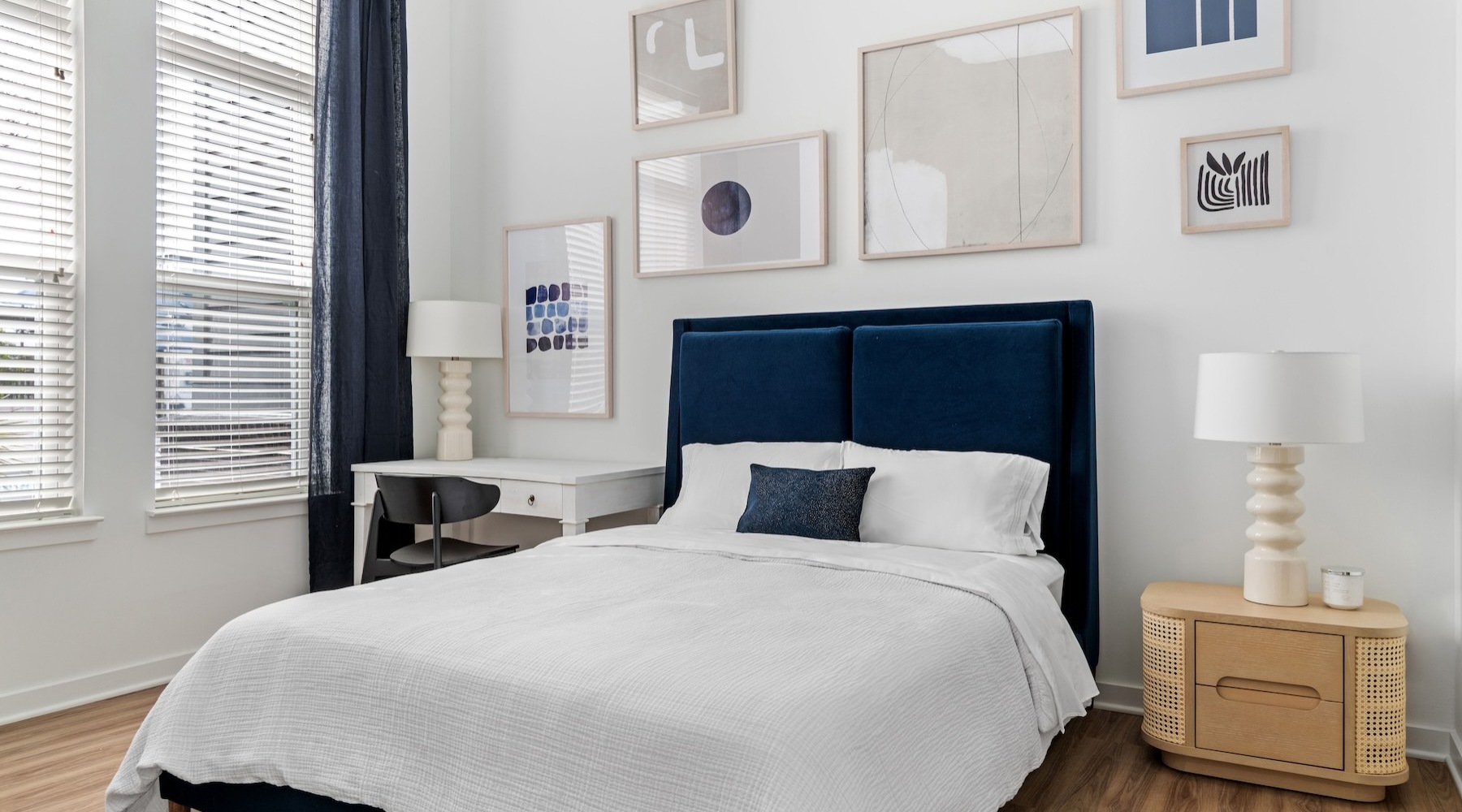 decorated bedroom with bed lamps and open tall windows